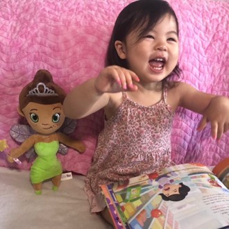 A child with a personalised milestone book from Hooray Heroes.