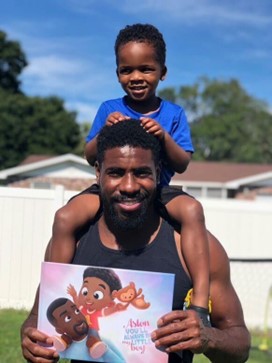 Boy and dad with a personalised book. 