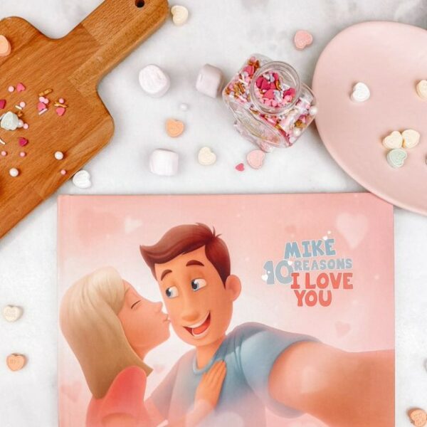 A Hooray Heroes personalised love book for couples, a cutting board and some Valentine's Day sweets.