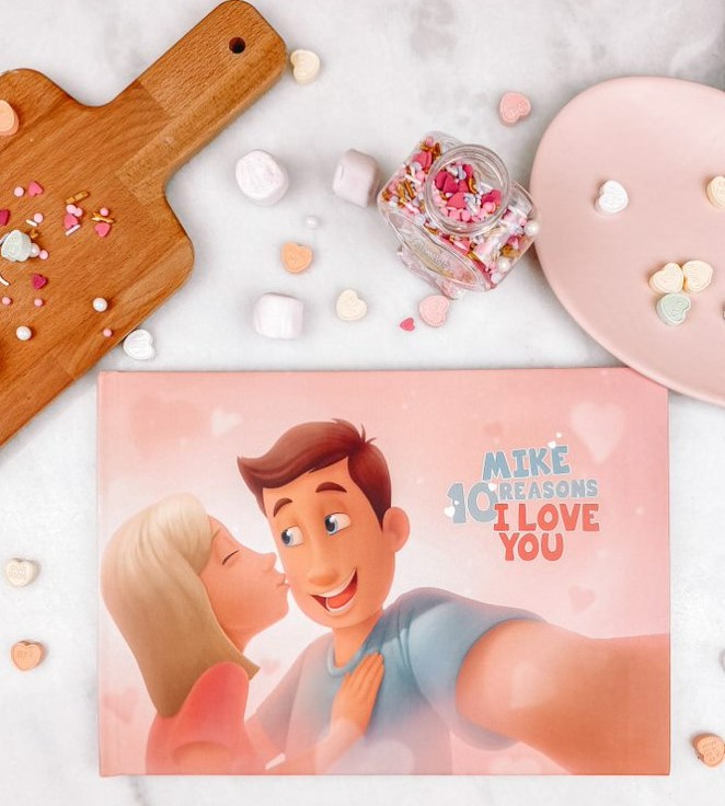 A Hooray Heroes personalised love book for couples, a cutting board and some Valentine's Day sweets.