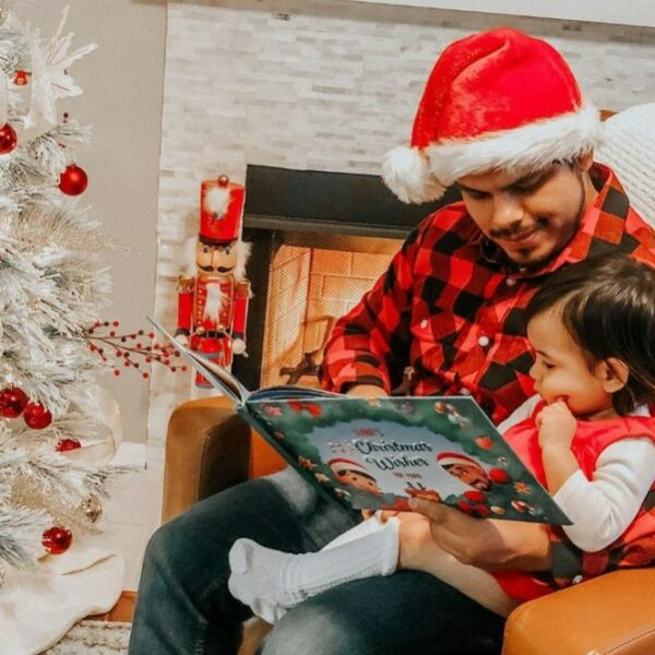 father reading a hooray heroes personalised christmas book to his child