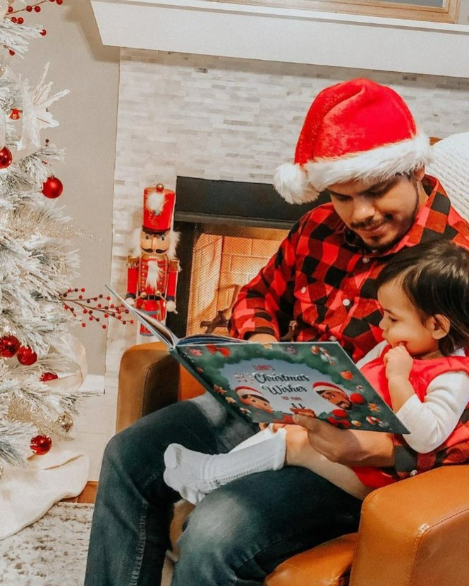 father reading a hooray heroes personalised christmas book to his child